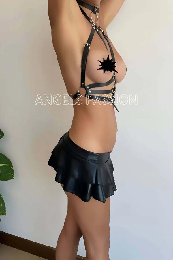 Model wearing black Adjustable Vegan Leather Chest Harness Top with silver alloy hardware and caged strap details front view